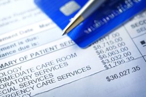 Person analyzing itemized hospital bill